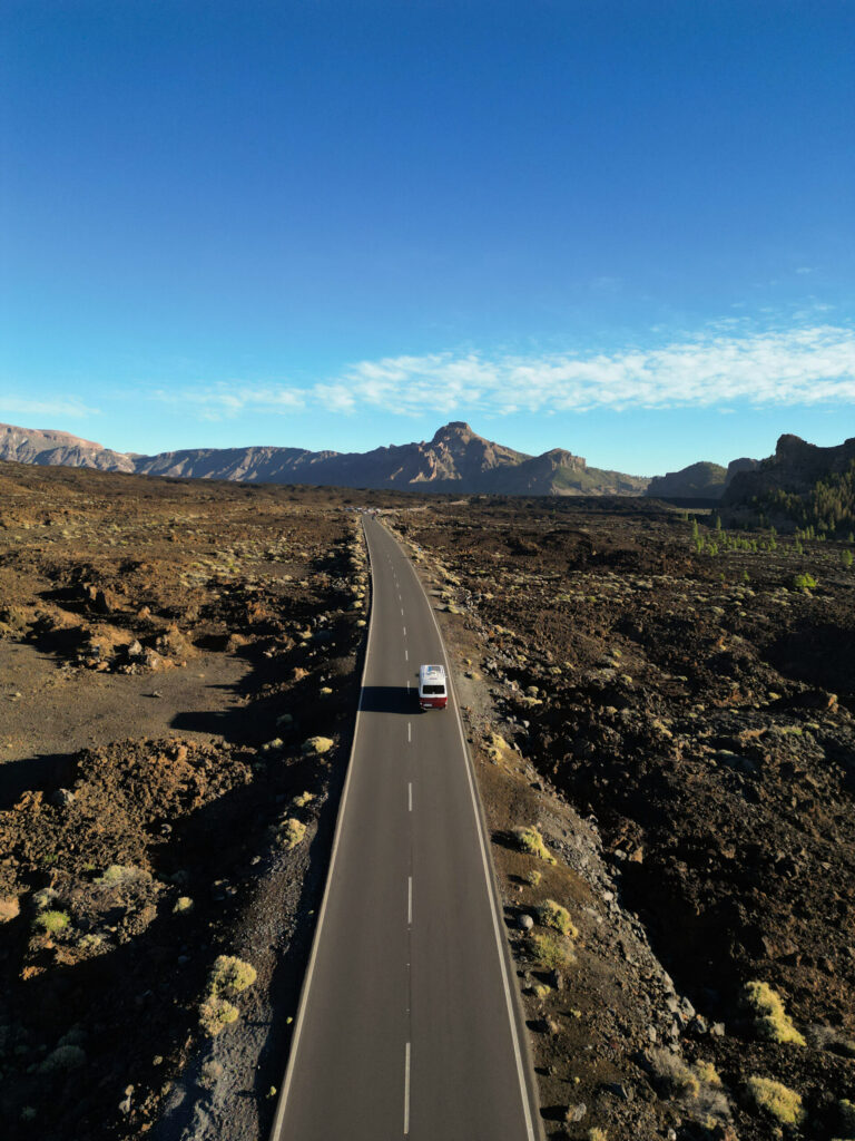 campervan driving on a road in Teide National Park Tenerife with volcanic landscape